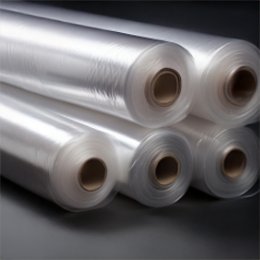 Several rolls of clear polyethylene tubing stacked on their cardboard cores.