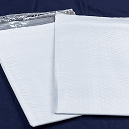 Two white Sure Seal Optimus mailers, the bubble lining showing through the surface.